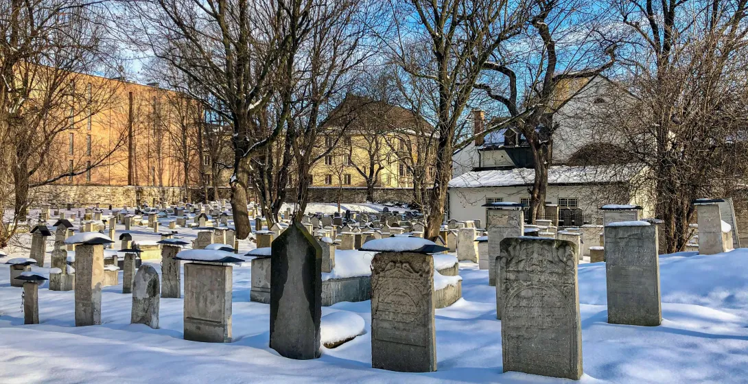 Snow-covered gravestones in Krakow's Old Jewish Cemetery.