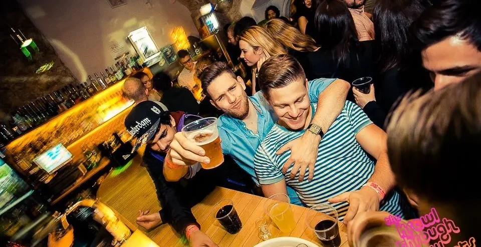 Friends enjoying a Krakow pub crawl.