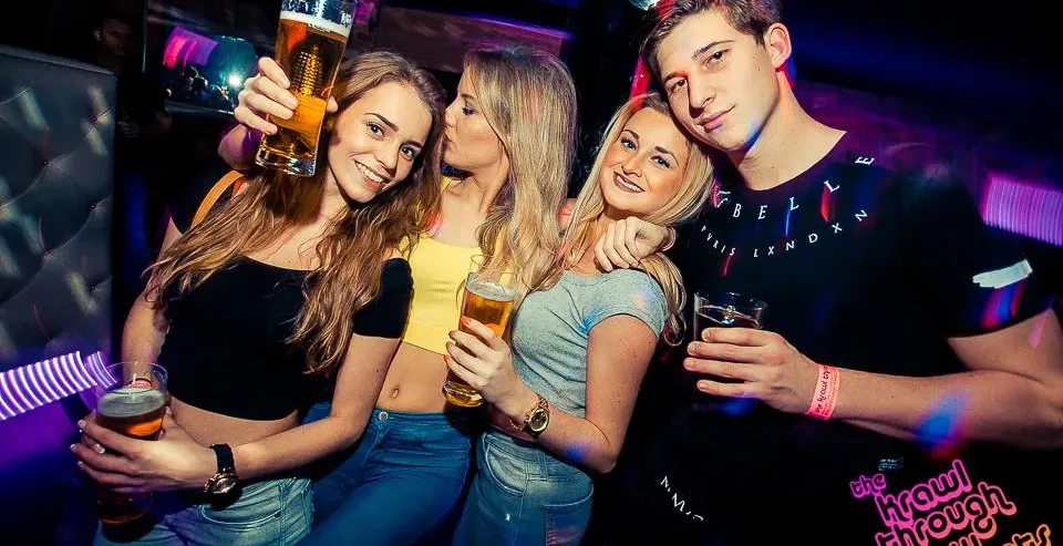 Group of friends enjoying a pub crawl in Krakow.