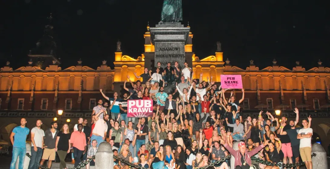 Large group enjoying a Krakow Pub Crawl at night.