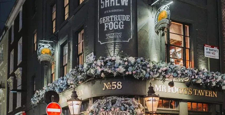 Mr. Fogg's Tavern in London at night, beautifully decorated.