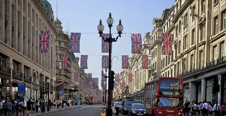 Festive Regent Street in London, adorned with Union Jack flags.