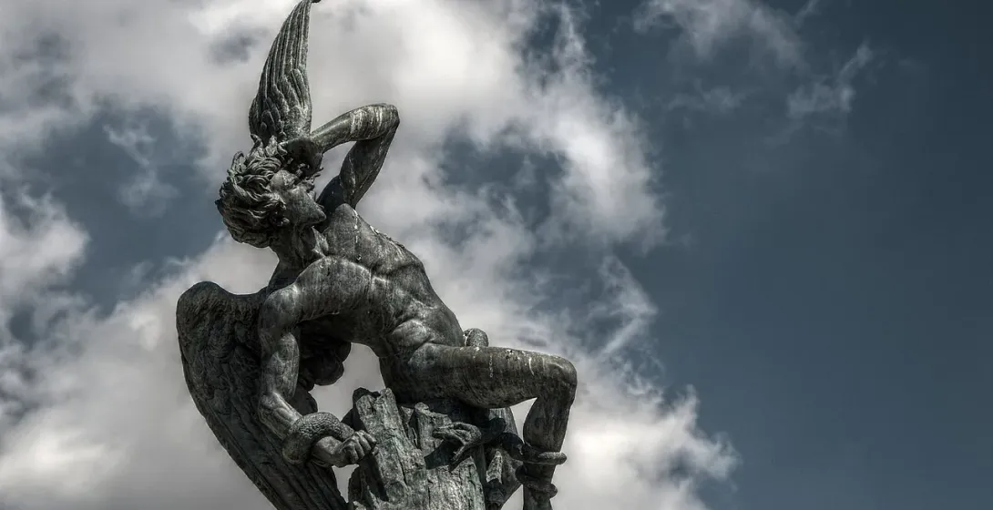 Dramatic bronze statue of a fallen angel in Madrid, Spain.