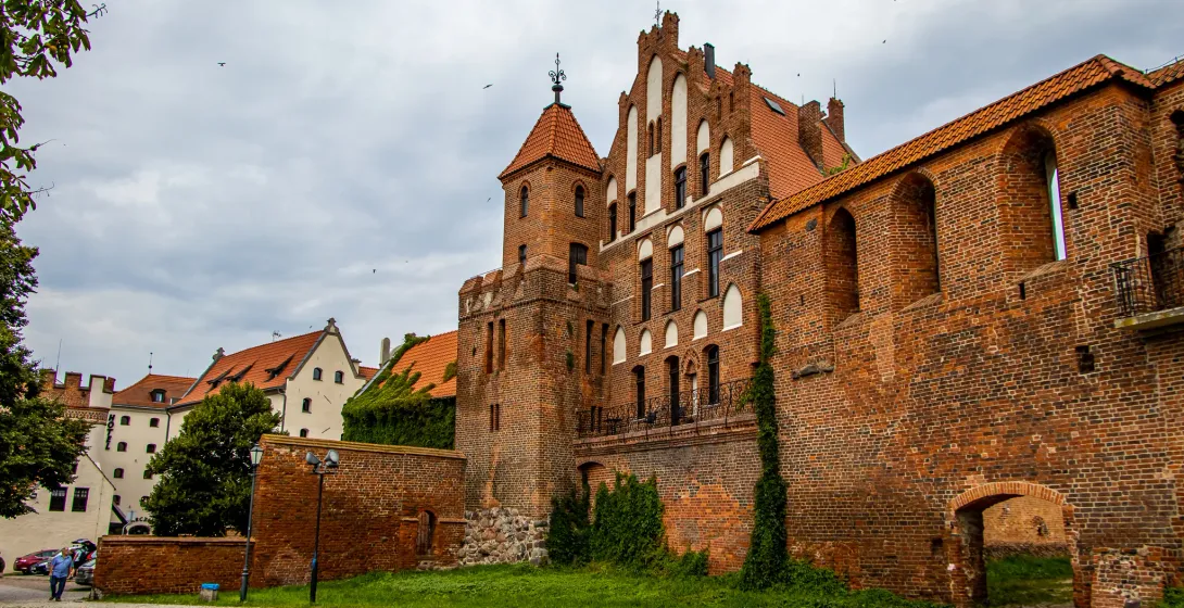 Explore the majestic Malbork Castle in Poland.