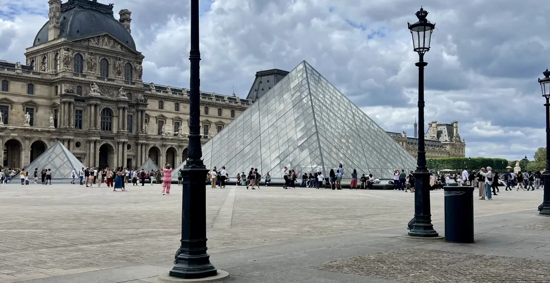 Tourists visit the Louvre Pyramid and Museum in Paris.