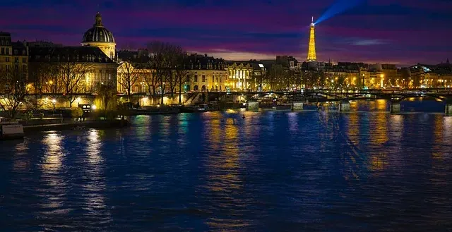 Paris at night: Eiffel Tower and Seine River.