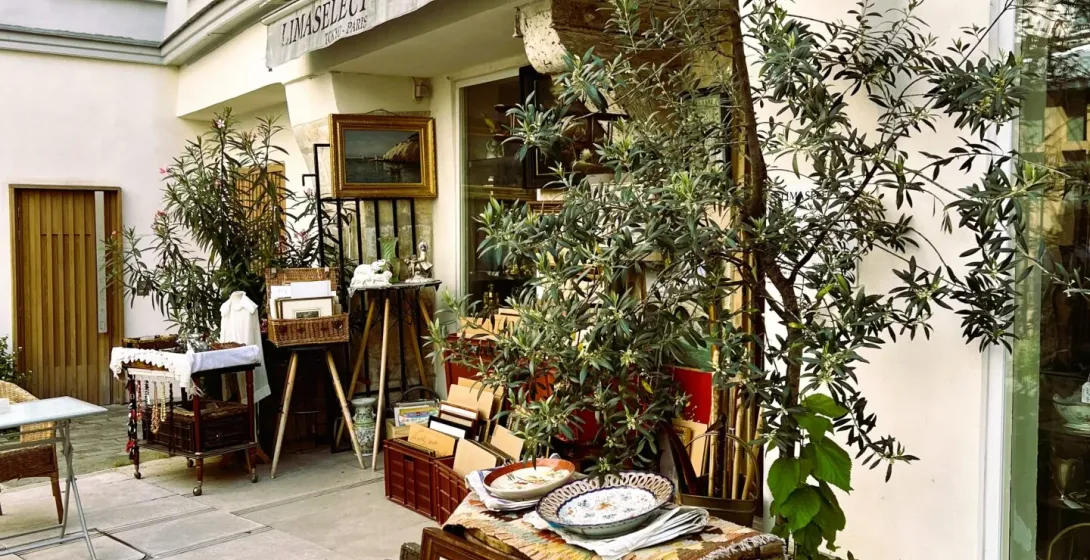 Antique shop in Paris displaying paintings and other treasures.