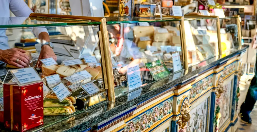 A beautifully decorated cheese counter in Paris, showcasing a variety of cheeses.