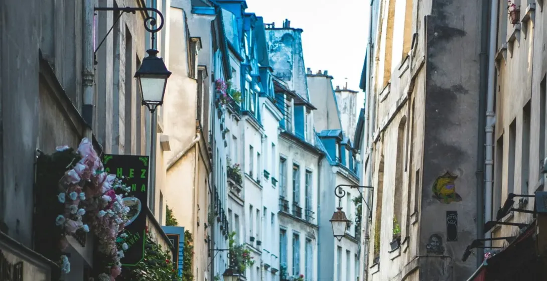 A charming Parisian alleyway with two people walking.