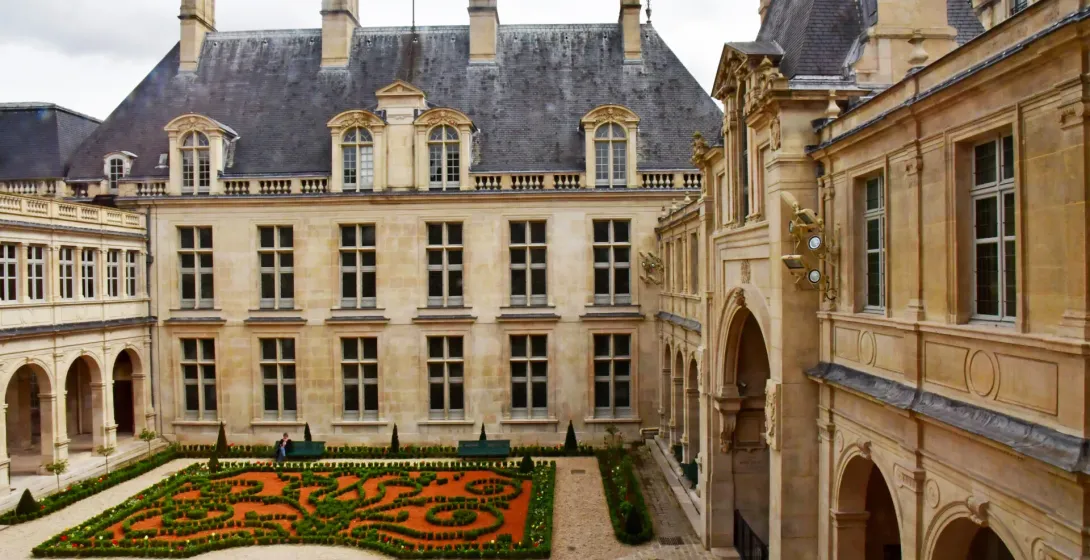 Tranquil courtyard garden in a historic Parisian building.