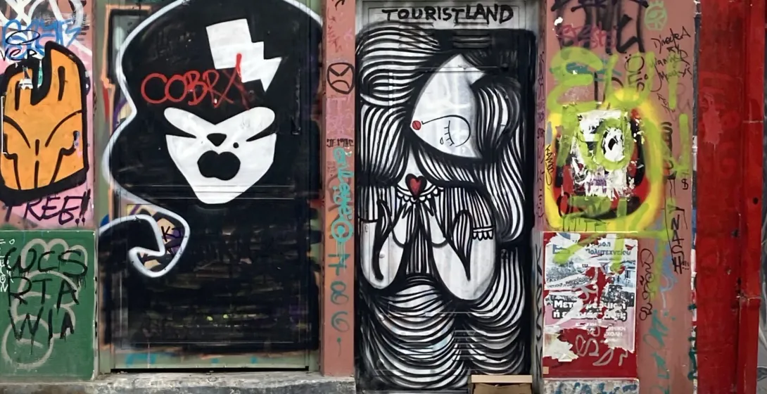 Street art murals on doorways in Athens.