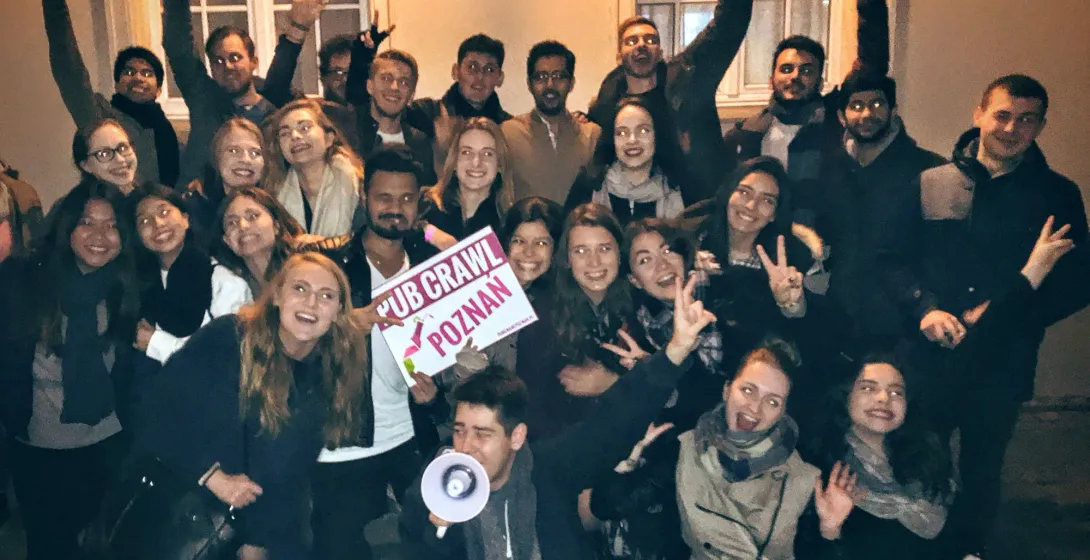 A large group enjoys a pub crawl tour in Poznan, Poland.