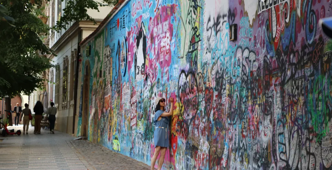Tourist at the colorful Lennon Wall in Prague.