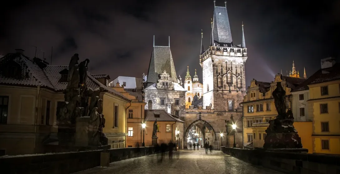 Night view of Prague's Old Town Bridge Tower during a Ghost & Legends Tour.