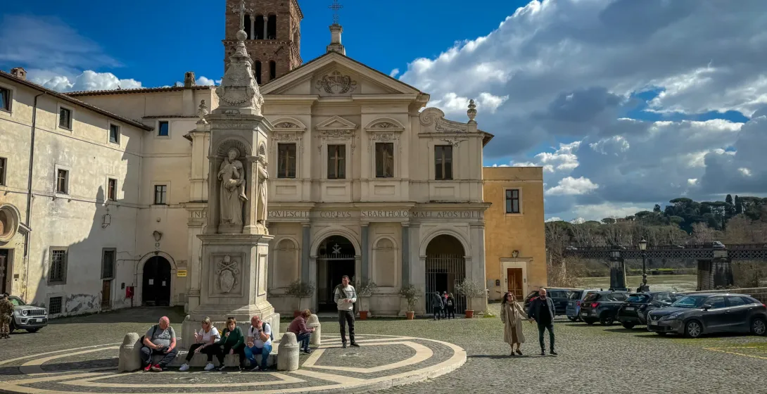 Tourists exploring the Basilica di San Bartolomeo all'Isola in Rome.