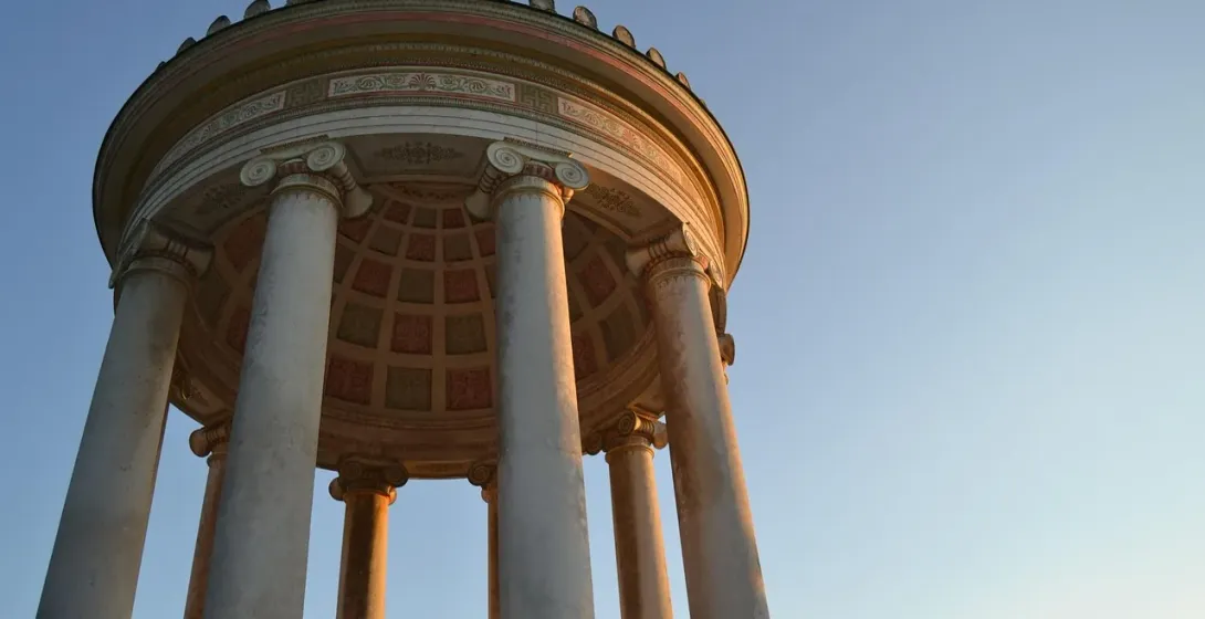 A couple admires the Temple of Diana in Rome at sunset.
