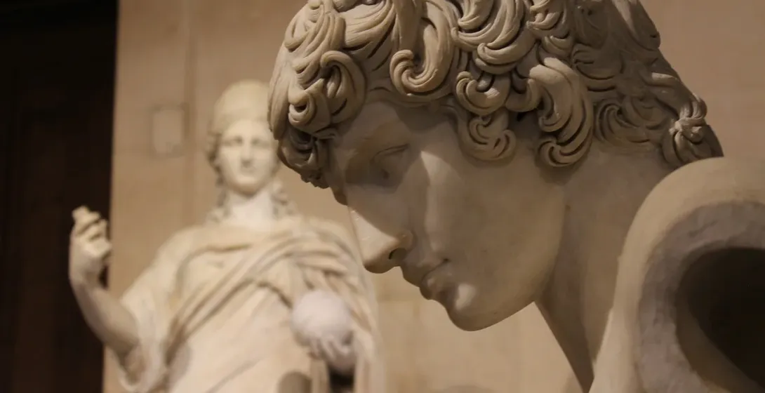 Close-up of a detailed marble statue in a Roman museum.