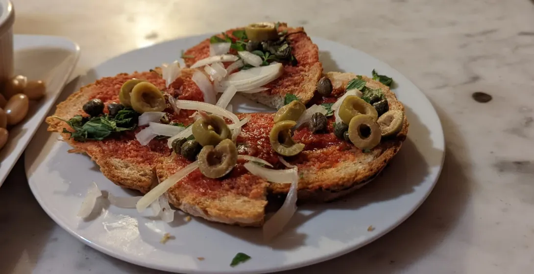 Delicious tapas with olives and capers on toasted bread in Rome.