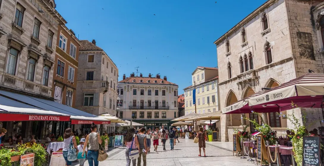 Tourists exploring a beautiful square in Split, Croatia.