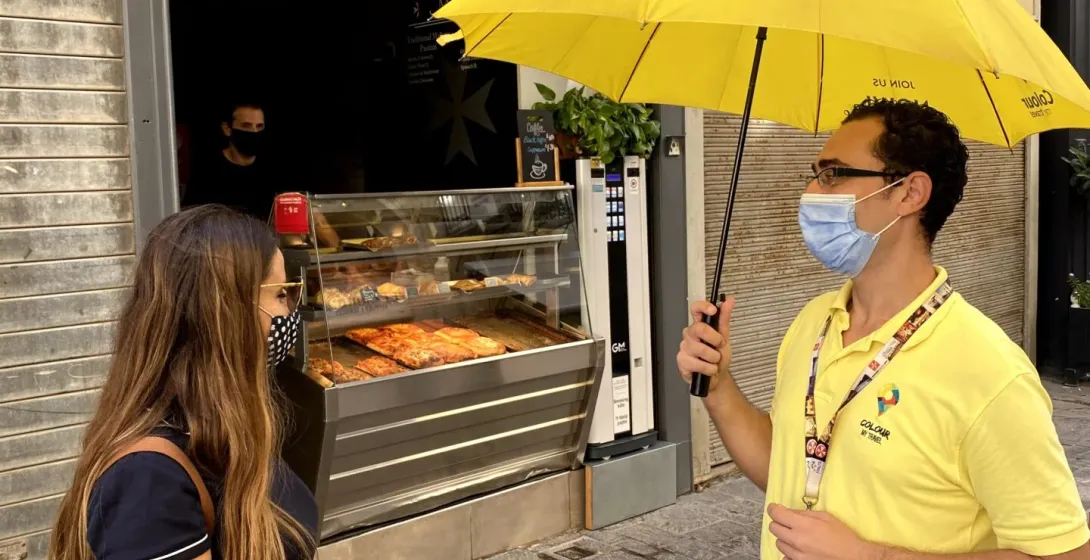 A tour guide greets a tourist in Valletta, Malta.