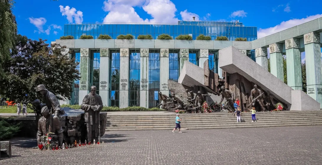 Tourists visit the poignant Monument to the Victims of the Warsaw Ghetto Uprising and the Palace of Justice in Warsaw.