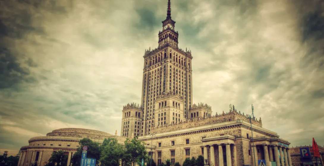 The Palace of Culture and Science in Warsaw under a dramatic sky.