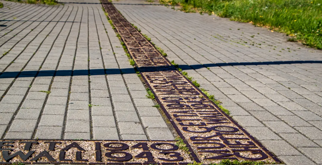 A metal inlay in a Warsaw pavement marks the location of the Ghetto Wall, commemorating the years 1940-1943.