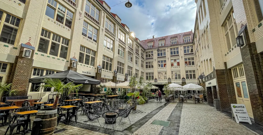 Picturesque courtyard in Wrocław, Poland, with cafes and restaurants.