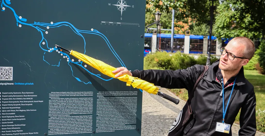 A tour guide in Wrocław, Poland, points to a map of the city's floodway system.