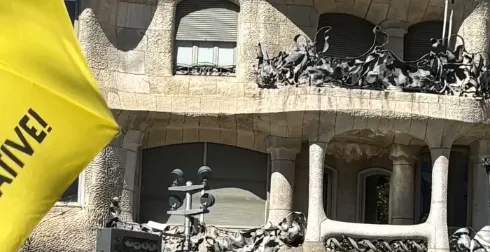 Antoni Gaudí's La Pedrera (Casa Milà) in Barcelona, with its wavy stone facade, iron balconies, and unique rooftop element...
