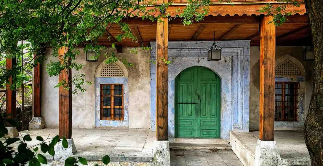 Serene entrance to a historical building with a vibrant green door.