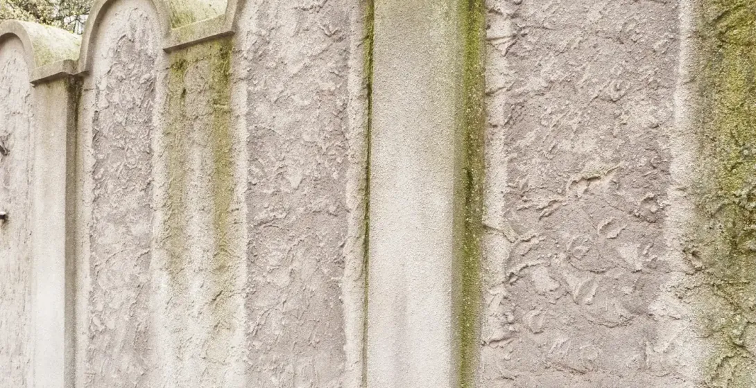 A section of the Krakow Ghetto wall memorial, whose arched top resembles a Jewish tombstone (matzevah).