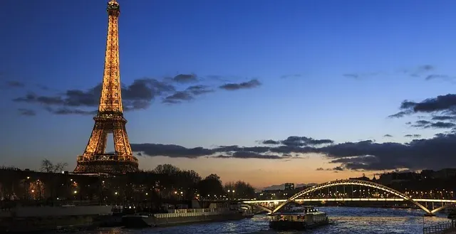 Eiffel Tower and Seine River at dusk in Paris.