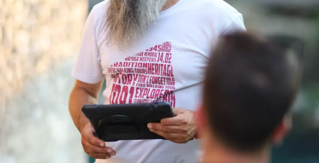 A tour guide leads a group on a walking tour.