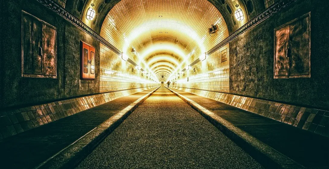 A long, illuminated tunnel invites exploration.