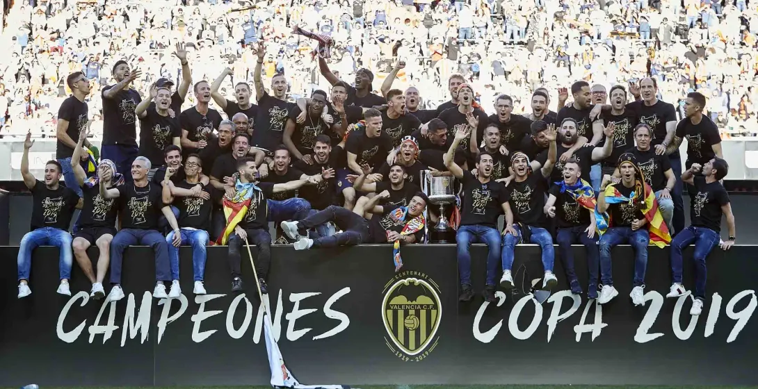 Valencia CF players celebrate winning the 2019 Copa del Rey in a stadium full of cheering fans.