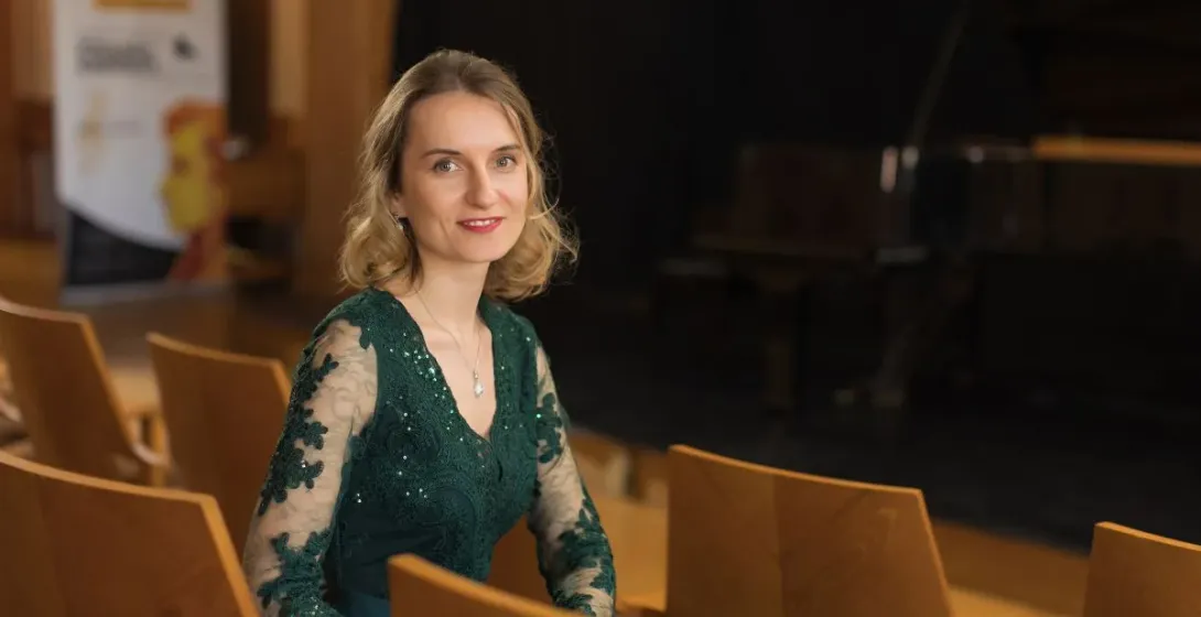 Woman in green dress at a concert.