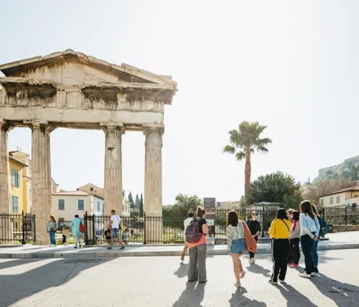 Tour group exploring the ancient Temple of Hephaestus in Athens, Greece.