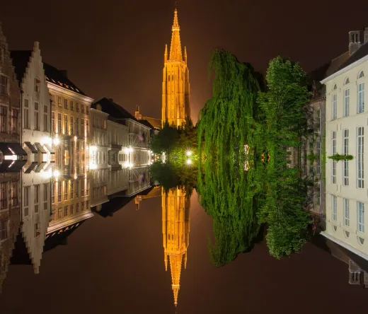 Bruges by Night: Stunning reflection of the Belfry and canals.