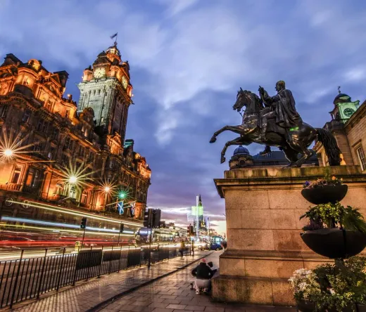 Edinburgh Old Town at night: Balmoral Hotel and King George IV statue.