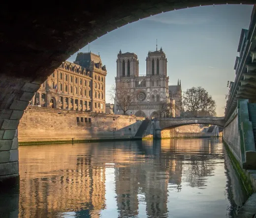 Stunning view of Notre Dame Cathedral in Paris, reflected in the Seine River.