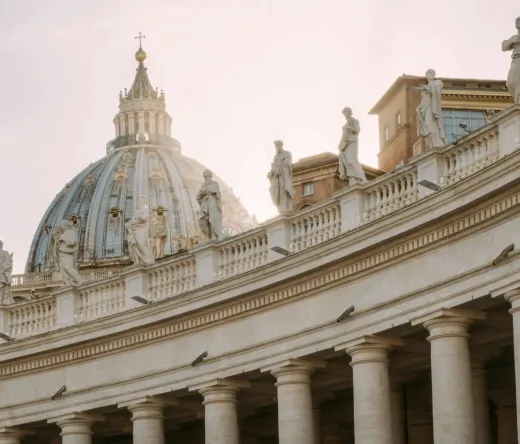 Statues and the dome of St. Peter's Basilica in Rome.