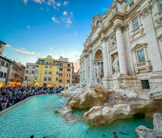 Tourists admiring the Trevi Fountain in Rome during a guided walking tour.