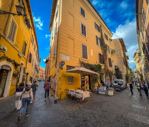 Tourists exploring the charming cobblestone streets of Trastevere, Rome.
