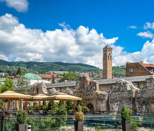 Sarajevo's Clock Tower and Roman ruins, a blend of history and modern life.