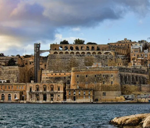 Historic Valletta waterfront in Malta, showcasing ancient fortifications and buildings.