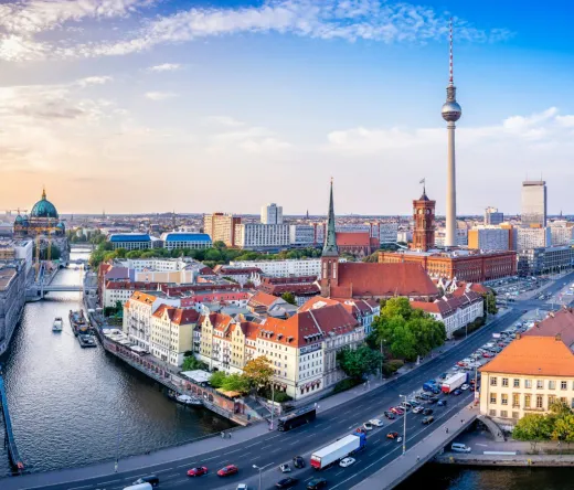 Panoramic view of Berlin's skyline at sunset, featuring iconic landmarks.