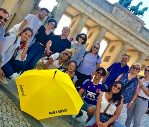 Happy tourists on a WALKATIVE! tour in front of Berlin's Brandenburg Gate.