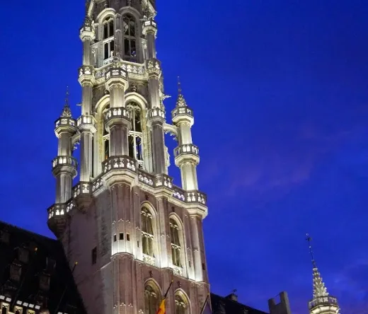 Brussels Town Hall at night, illuminated against the dark sky.