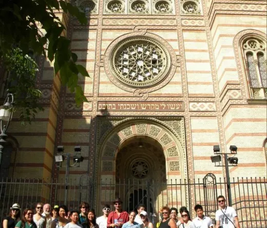A tour group poses in front of the stunning Dohány Street Synagogue in Budapest.